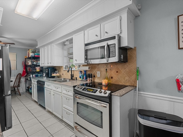 3628 Avenue E 1/2 Ave E 1/2, Santa Fe, TX 77510 - kitchen with stainless steel appliances, a sink, tasteful backsplash, crown molding, and white cabinetry