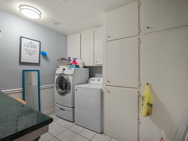 3628 Avenue E 1/2 Ave E 1/2, Santa Fe, TX 77510 - washroom featuring cabinet space, washer and clothes dryer, light tile patterned flooring, and a textured ceiling
