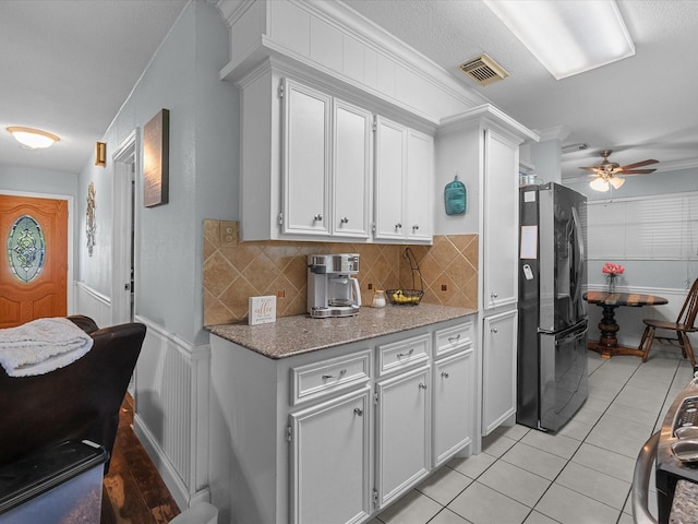 3628 Avenue E 1/2 Ave E 1/2, Santa Fe, TX 77510 - kitchen featuring freestanding refrigerator, a ceiling fan, backsplash, light stone countertops, and white cabinetry
