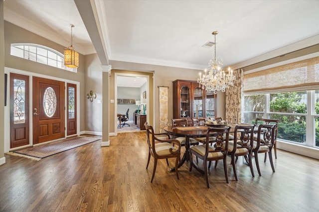 3923 Drake St, Houston, TX 77005 - dining room with a chandelier, wood finished floors, baseboards, and ornamental molding