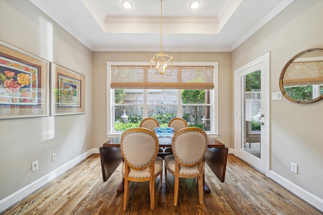 3923 Drake St, Houston, TX 77005 - dining area featuring a chandelier, wood finished floors, a tray ceiling, baseboards, and crown molding