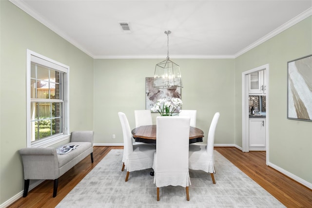 3803 Sunset Blvd, West University Place, TX 77005 - dining space with a chandelier, wood finished floors, ornamental molding, and baseboards
