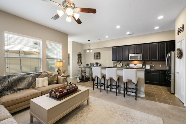 9135 Solvista Pass Ln, Houston, TX 77070 - living room with recessed lighting, a ceiling fan, light colored carpet, and light tile patterned floors
