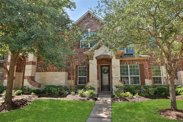 9135 Solvista Pass Ln, Houston, TX 77070 - view of front of home featuring a front lawn, brick siding, and stone siding