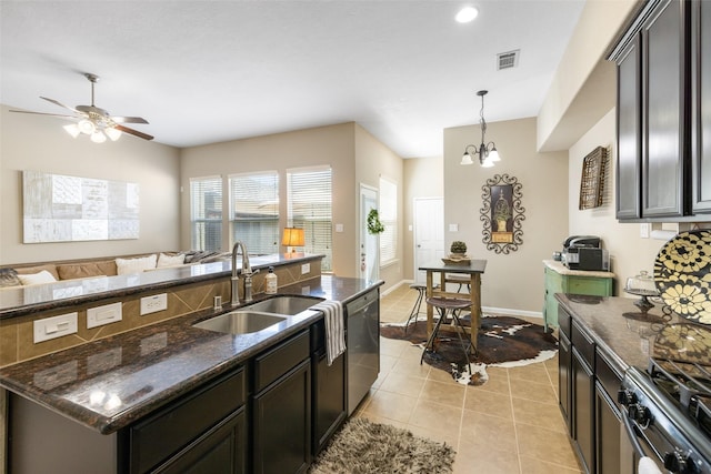 9135 Solvista Pass Ln, Houston, TX 77070 - kitchen featuring a sink, stainless steel appliances, dark stone countertops, a ceiling fan, and open floor plan