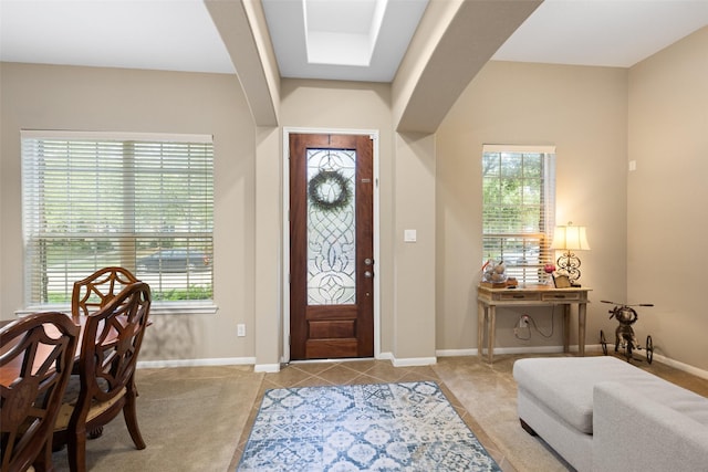 9135 Solvista Pass Ln, Houston, TX 77070 - entryway with baseboards, light tile patterned flooring, and light carpet