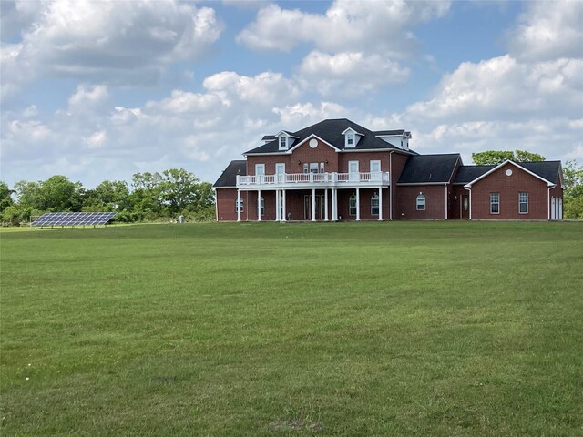 2709 Flores Bayou Bridge Rd, Angleton, TX 77515 - rear view of house with a yard, brick siding, and a deck