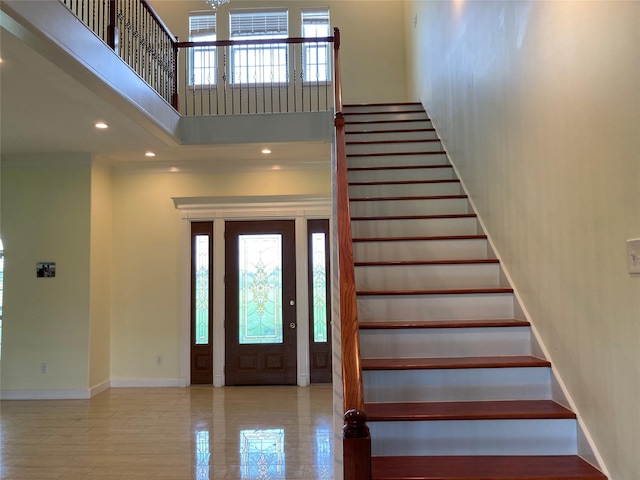2709 Flores Bayou Bridge Rd, Angleton, TX 77515 - foyer entrance featuring a towering ceiling, stairs, baseboards, and recessed lighting