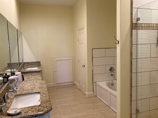 2709 Flores Bayou Bridge Rd, Angleton, TX 77515 - full bath featuring double vanity, a bath, and baseboards