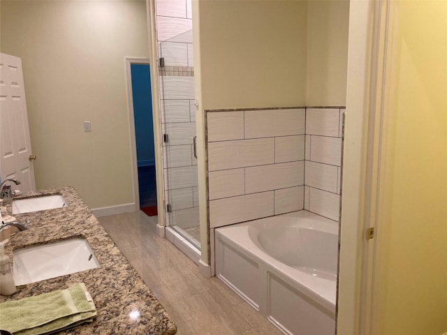 2709 Flores Bayou Bridge Rd, Angleton, TX 77515 - bathroom featuring a garden tub, a stall shower, baseboards, and double vanity