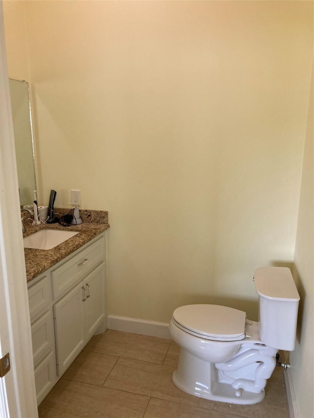 2709 Flores Bayou Bridge Rd, Angleton, TX 77515 - half bath with vanity, toilet, baseboards, and tile patterned flooring