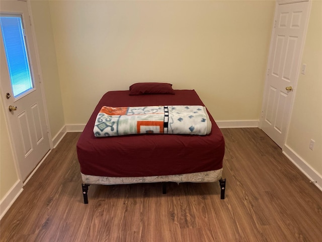 2709 Flores Bayou Bridge Rd, Angleton, TX 77515 - bedroom with dark wood-style floors and baseboards