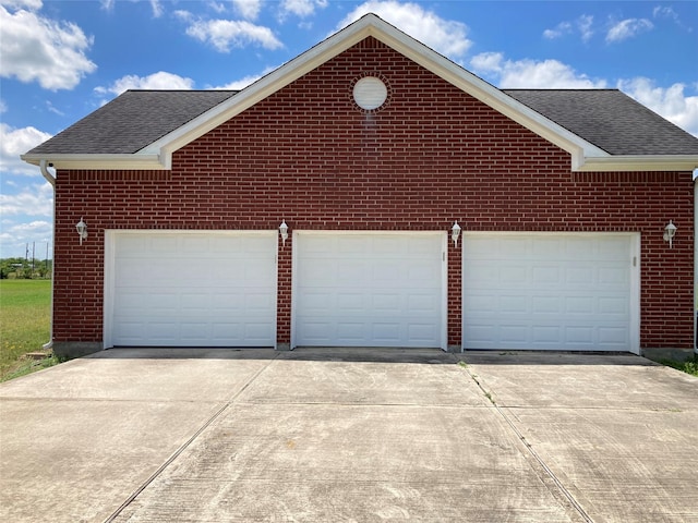 2709 Flores Bayou Bridge Rd, Angleton, TX 77515 - view of property exterior featuring driveway, a shingled roof, and brick siding