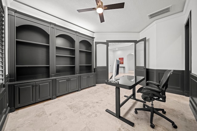 3 Amulet Oaks Pl, The Woodlands, TX 77382 - office area with crown molding, a textured ceiling, ceiling fan, a wainscoted wall, and built in shelves