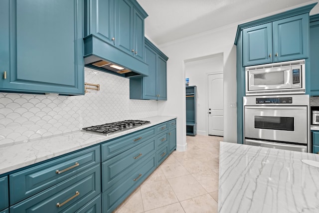 3 Amulet Oaks Pl, The Woodlands, TX 77382 - kitchen with stainless steel appliances, crown molding, decorative backsplash, light stone countertops, and under cabinet range hood