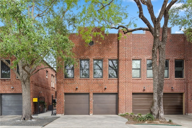 1728 Nicholson St, Houston, TX 77008 - view of front of house with concrete driveway, an attached garage, and brick siding