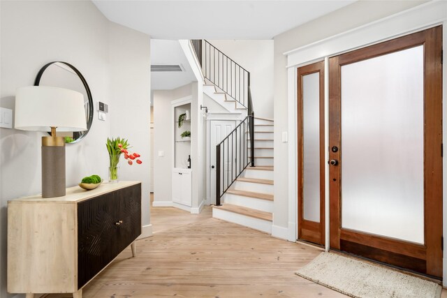 1728 Nicholson St, Houston, TX 77008 - entrance foyer featuring light wood-style floors, stairway, and baseboards