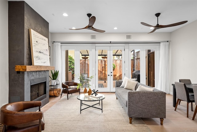 1728 Nicholson St, Houston, TX 77008 - living room featuring a ceiling fan, french doors, recessed lighting, a large fireplace, and light wood-style flooring