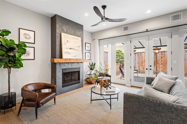 1728 Nicholson St, Houston, TX 77008 - living room with light wood finished floors, ceiling fan, french doors, a high end fireplace, and recessed lighting