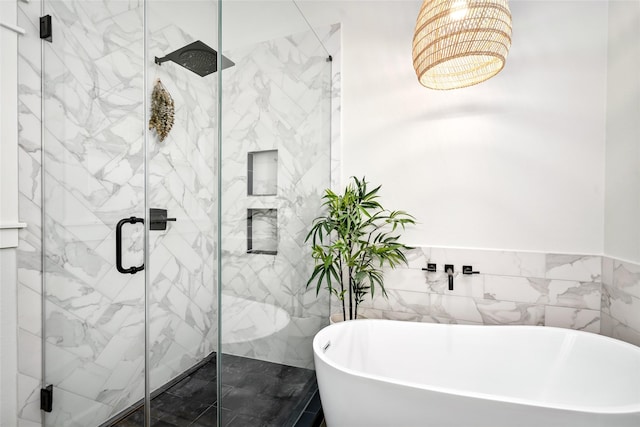 1728 Nicholson St, Houston, TX 77008 - bathroom featuring a freestanding bath, a marble finish shower, a chandelier, and tile walls