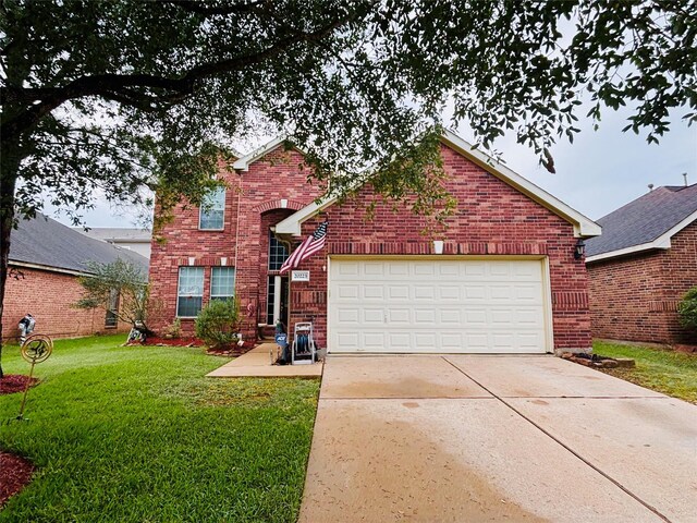 20223 Benton Springs Ln, Richmond, TX 77407 - traditional-style home with brick siding, a front lawn, and concrete driveway