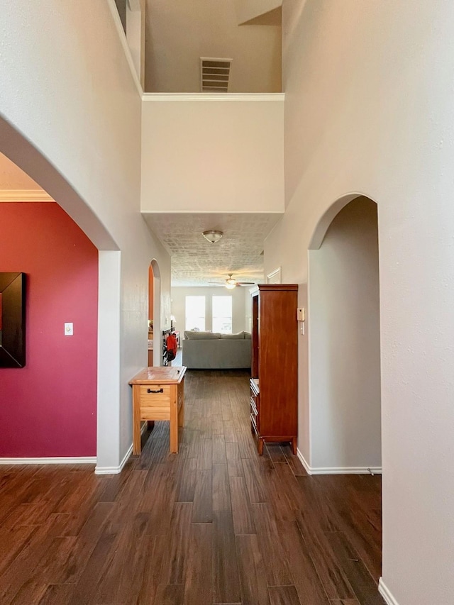 20223 Benton Springs Ln, Richmond, TX 77407 - hall with arched walkways, wood finished floors, baseboards, and a towering ceiling