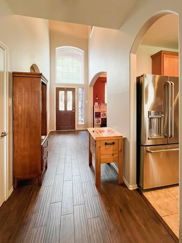 20223 Benton Springs Ln, Richmond, TX 77407 - entrance foyer with wood finished floors, arched walkways, baseboards, and a high ceiling