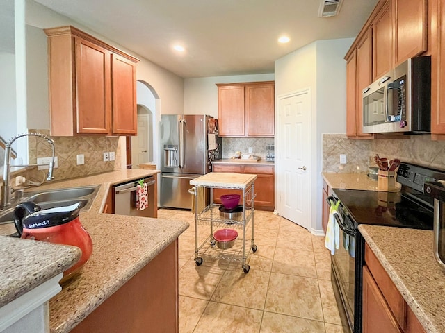 20223 Benton Springs Ln, Richmond, TX 77407 - kitchen with stainless steel appliances, a sink, decorative backsplash, light tile patterned floors, and recessed lighting