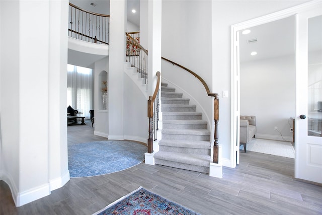 3207 Sweet Audrey Ln, Richmond, TX 77406 - stairs with wood finished floors, baseboards, recessed lighting, and a towering ceiling