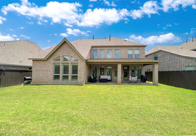 3207 Sweet Audrey Ln, Richmond, TX 77406 - rear view of house featuring brick siding, a patio area, an outdoor living space, and roof with shingles
