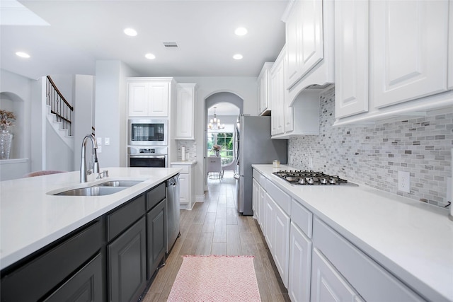 3207 Sweet Audrey Ln, Richmond, TX 77406 - kitchen featuring a sink, appliances with stainless steel finishes, white cabinets, light countertops, and light wood-style flooring