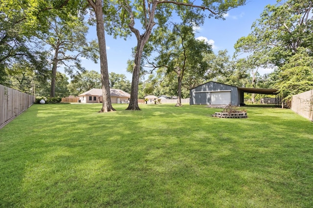 25187 Hill And Dale Ave, Splendora, TX 77372 - view of yard with a detached garage, an outdoor structure, and a pole building