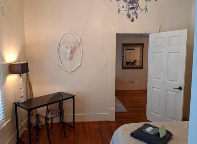 4204 Stanford St, Houston, TX 77006 - bedroom featuring wood finished floors, baseboards, and a chandelier