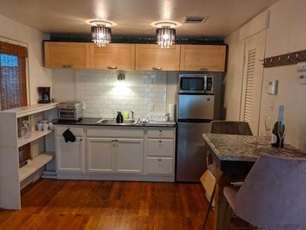 4204 Stanford St, Houston, TX 77006 - kitchen featuring stainless steel appliances, a sink, decorative backsplash, and dark wood-style floors