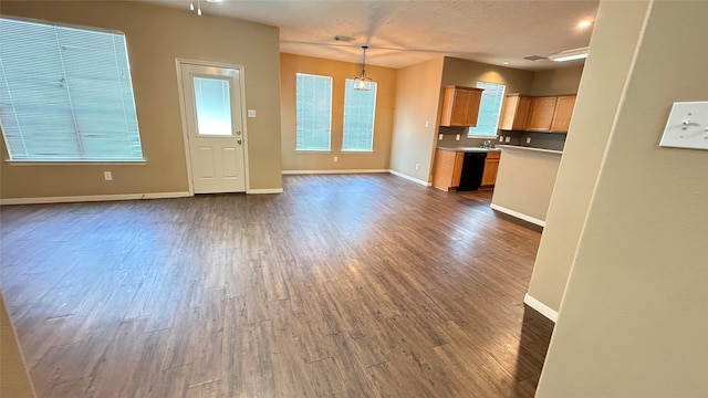 19646 Ballina Meadows Dr, Katy, TX 77449 - unfurnished living room featuring dark wood-style floors and baseboards