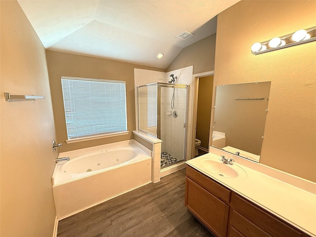 19646 Ballina Meadows Dr, Katy, TX 77449 - bathroom featuring wood finished floors, vaulted ceiling, toilet, a stall shower, and a whirlpool tub