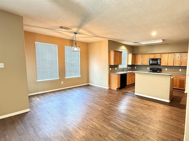 19646 Ballina Meadows Dr, Katy, TX 77449 - kitchen with black appliances, light countertops, dark wood finished floors, a textured ceiling, and baseboards