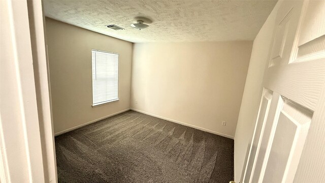 19646 Ballina Meadows Dr, Katy, TX 77449 - unfurnished room featuring dark carpet, a textured ceiling, and baseboards