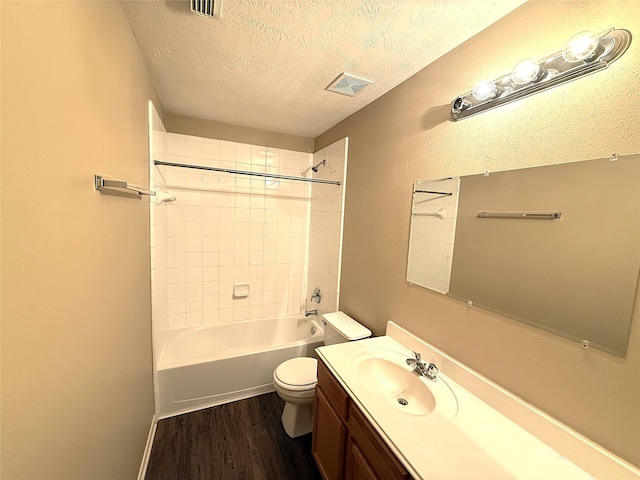 19646 Ballina Meadows Dr, Katy, TX 77449 - bathroom featuring a textured ceiling, toilet, wood finished floors, vanity, and washtub / shower combination