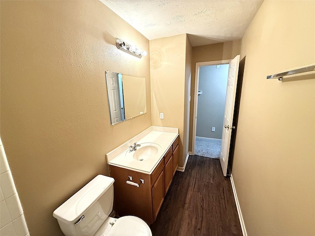 19646 Ballina Meadows Dr, Katy, TX 77449 - bathroom with wood finished floors, vanity, toilet, a textured ceiling, and baseboards