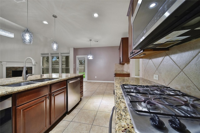 12119 Bayou Junction Rd, Cypress, TX 77433 - kitchen featuring a sink, stainless steel appliances, tasteful backsplash, light tile patterned floors, and hanging light fixtures