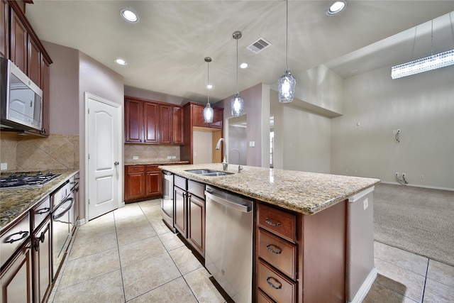 12119 Bayou Junction Rd, Cypress, TX 77433 - kitchen featuring stainless steel appliances, a sink, light stone countertops, backsplash, and light tile patterned floors