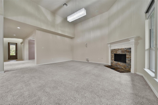 12119 Bayou Junction Rd, Cypress, TX 77433 - unfurnished living room with carpet, a high ceiling, a fireplace, and baseboards