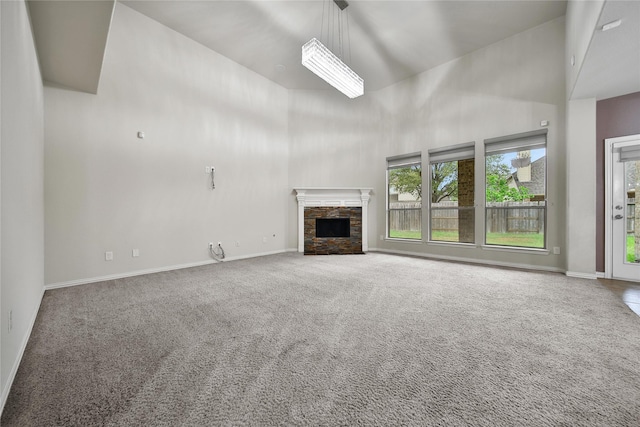12119 Bayou Junction Rd, Cypress, TX 77433 - unfurnished living room featuring a towering ceiling, plenty of natural light, carpet floors, and a fireplace