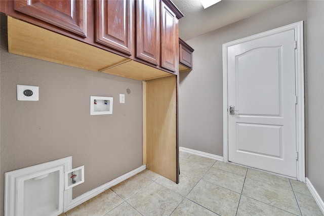 12119 Bayou Junction Rd, Cypress, TX 77433 - laundry area with hookup for a washing machine, hookup for an electric dryer, baseboards, cabinet space, and light tile patterned floors
