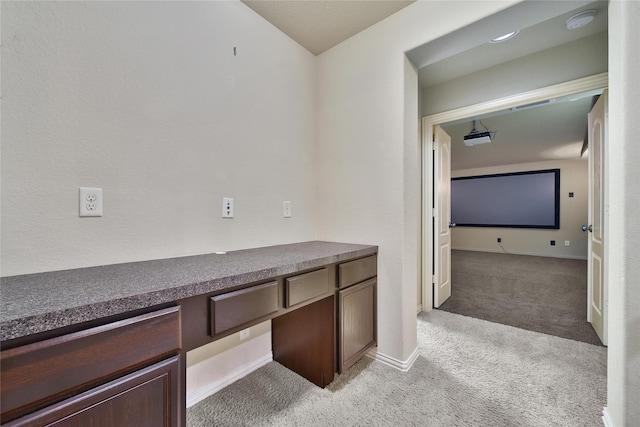 12119 Bayou Junction Rd, Cypress, TX 77433 - hallway with light carpet, a desk, and baseboards