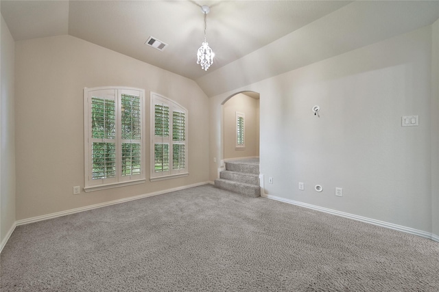 12119 Bayou Junction Rd, Cypress, TX 77433 - carpeted spare room featuring arched walkways, lofted ceiling, baseboards, a chandelier, and stairway