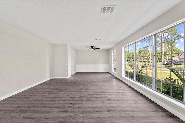 9110 Vickijohn Dr, Houston, TX 77031 - empty room featuring dark wood-style floors, a ceiling fan, and baseboards