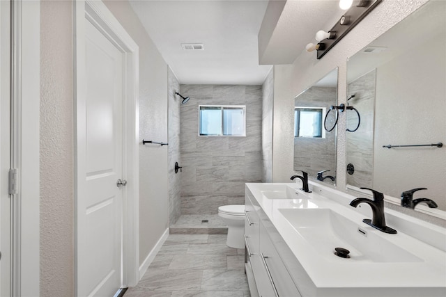 9110 Vickijohn Dr, Houston, TX 77031 - bathroom with tiled shower, toilet, double vanity, a textured wall, and marble finish floors