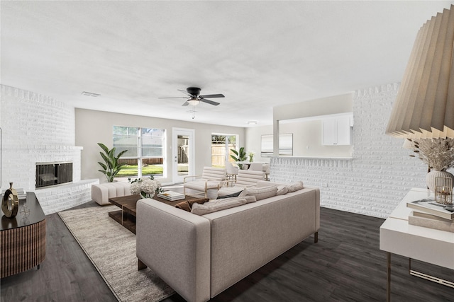 9110 Vickijohn Dr, Houston, TX 77031 - living area with dark wood-type flooring, ceiling fan, and a fireplace